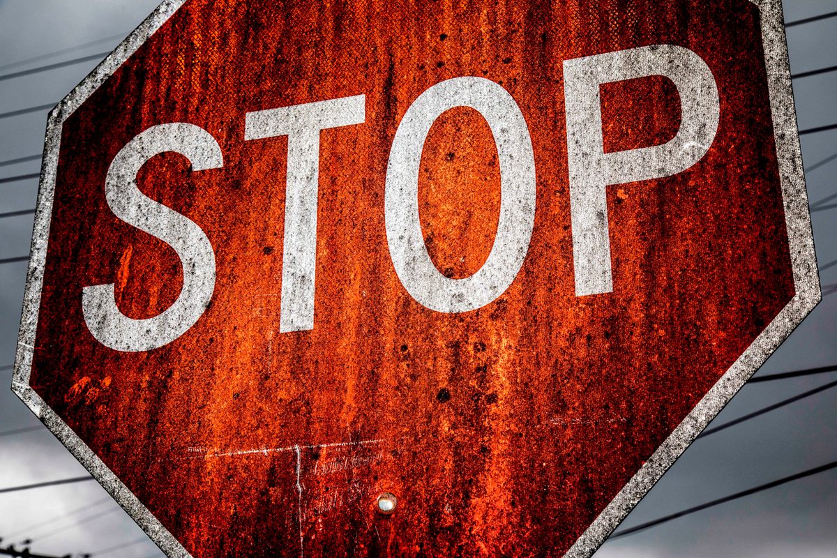 This Louisville stop sign is slathered in black discharge from various whiskey distilleries in the area.