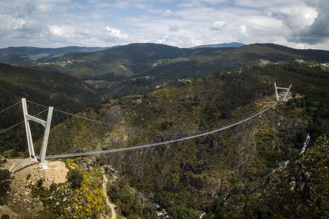 The 516 Arouca Bridge is suspended above the Paiva River.
