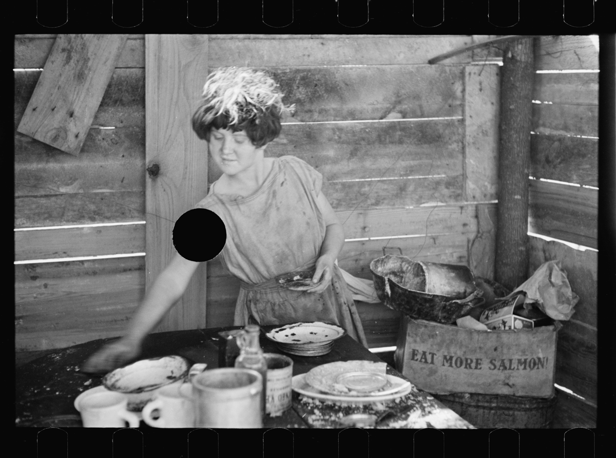<em>Untitled photo, possibly related to: Twelve-year old girl of family of nine, cooking meal in rude, open lean-to near hut, Tennessee</em>.