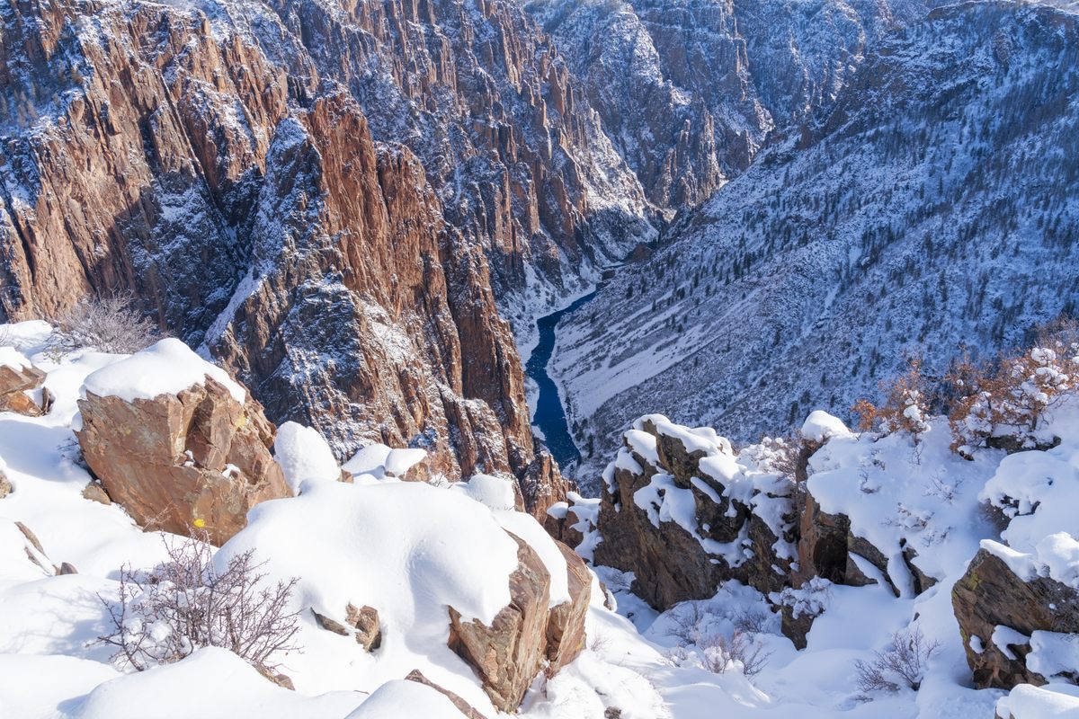 The Gunnison River is festooned by majestic steep cliffs in glorious winter light.