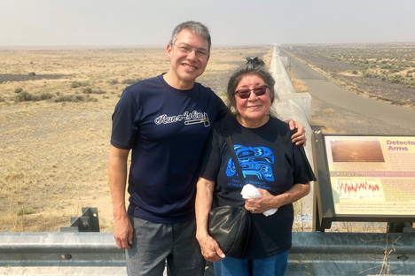Gray and Yellowfly standing beside one of the interferometer at LIGO's 2.5-mile-long arms.