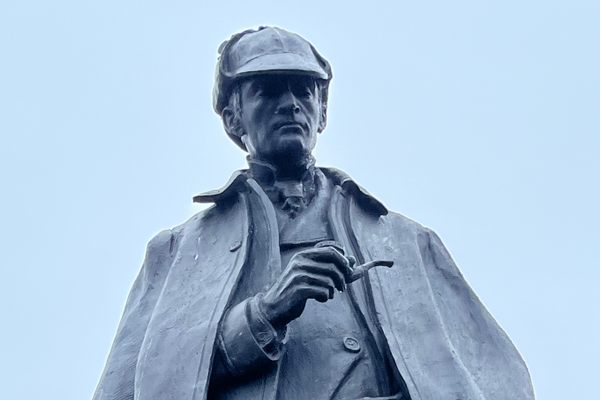 Close up of Sherlock Holmes’ face with pipe in hand