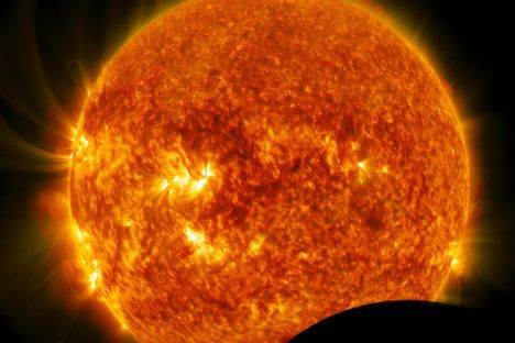 The temperature of the Sun's surface is about 5,600 degrees Celsius (10,000 degrees Fahrenheit). That's hot, but nowhere near the temperature needed to cook electrons off iron.