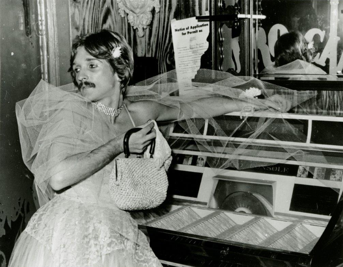 Partier Wayne (surname unknown) dressed in drag at the Castro Café on Halloween 1976.