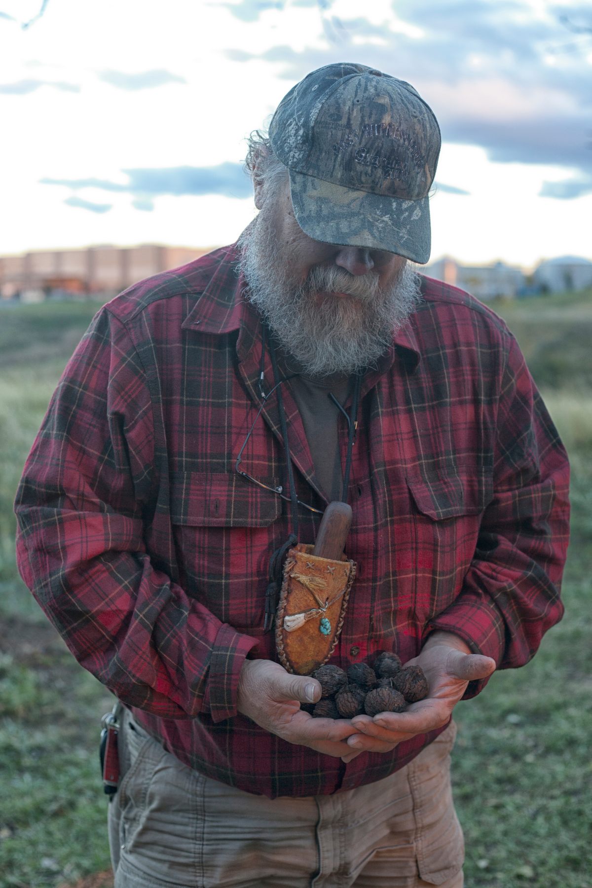 Marion cradling a handful of de-husked black walnuts.