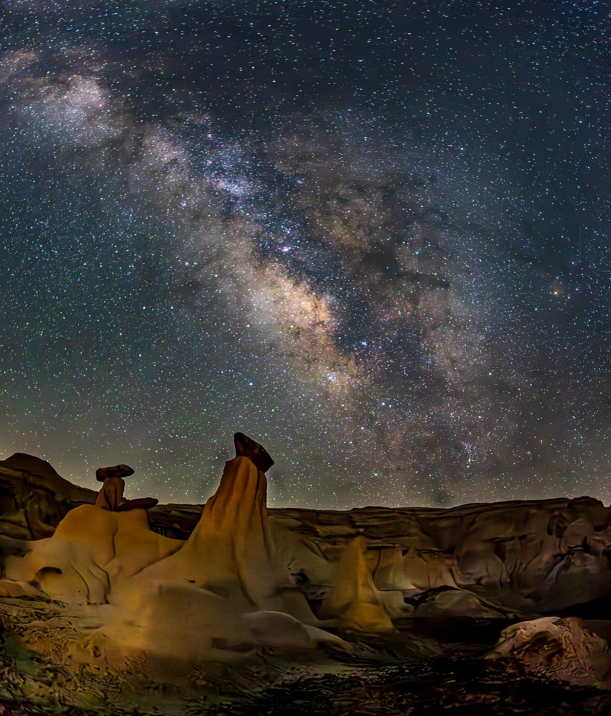 Jonathan Chan's photograph of the Milky Way over yellow hoodoos in the Ah-shi-sle-pah Wilderness of New Mexico.