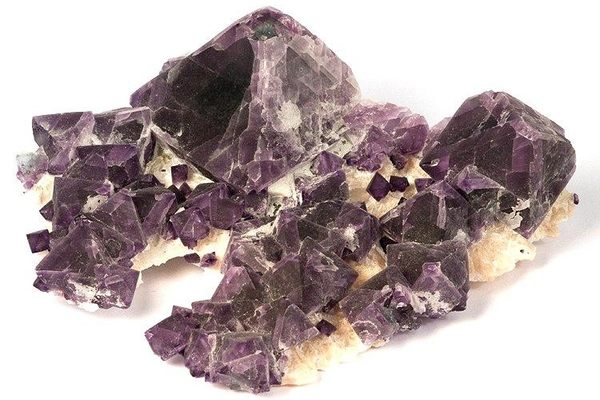 Purple fluorite similar to this specimen mined in China can be found at the Museum of Minerals and Crystals.