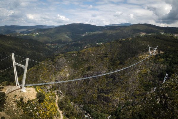 The 516 Arouca Bridge is suspended above the Paiva River.