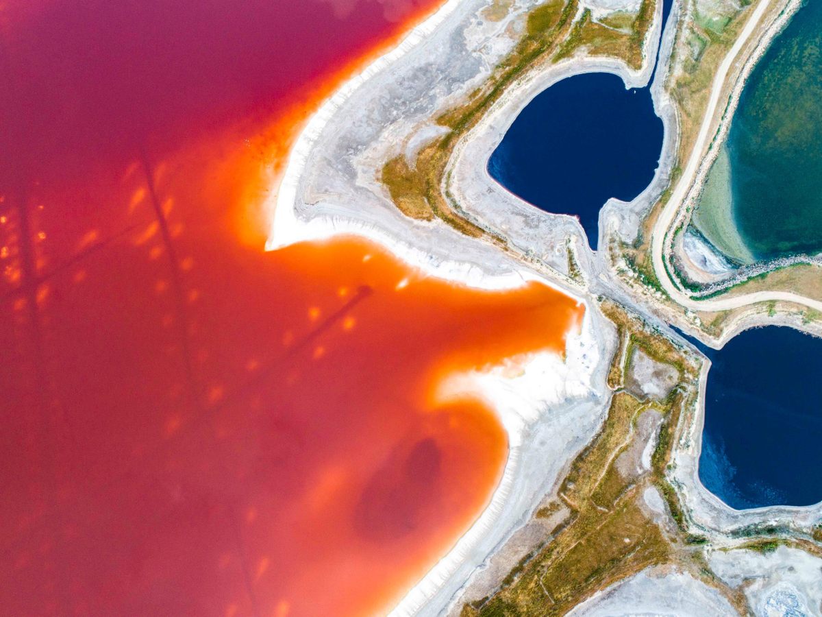 Algae turn the lake rainbow in the summer.