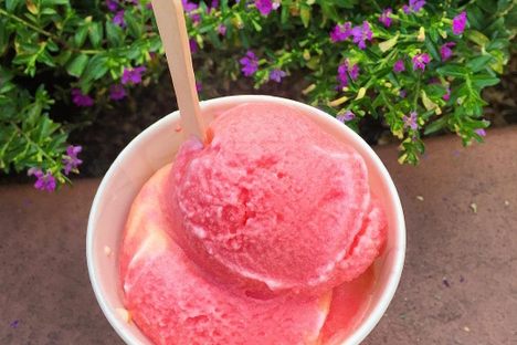 Scoops of strawberry sit atop pineapple guri guri.