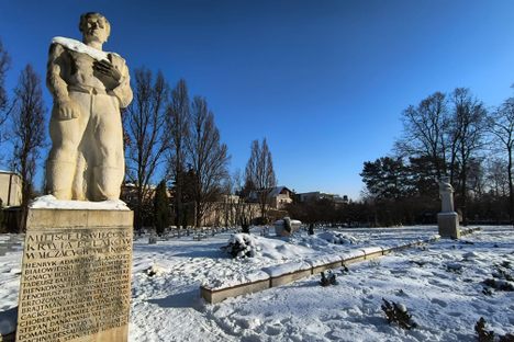 Sculptures crafted by noted artist Józef Gazy flank the rows of symbolic graves.