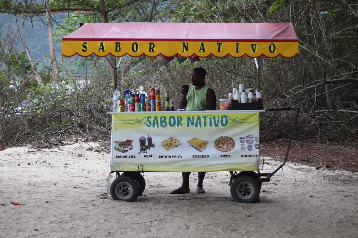 Moises, a street vendor, makes a living selling food and drinks to tourists.