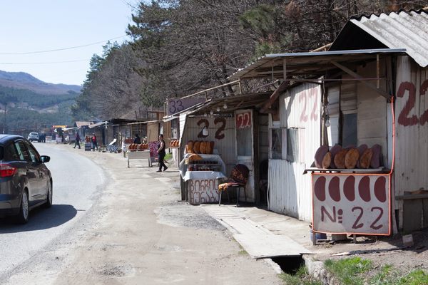 The strip of road is dotted with bakers' stalls. 