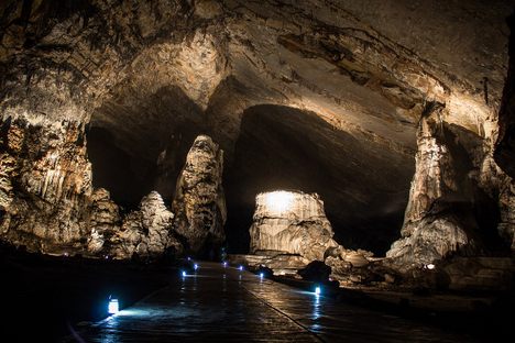 Inside the caves, paths and features are brightly illuminated.