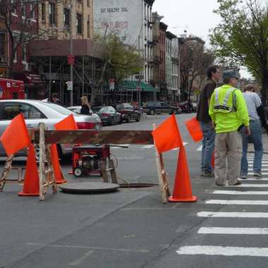 Manhole cover in busy Brooklyn intersection - the only way in