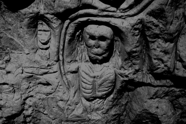 Mysterious skeleton carving in the cave.