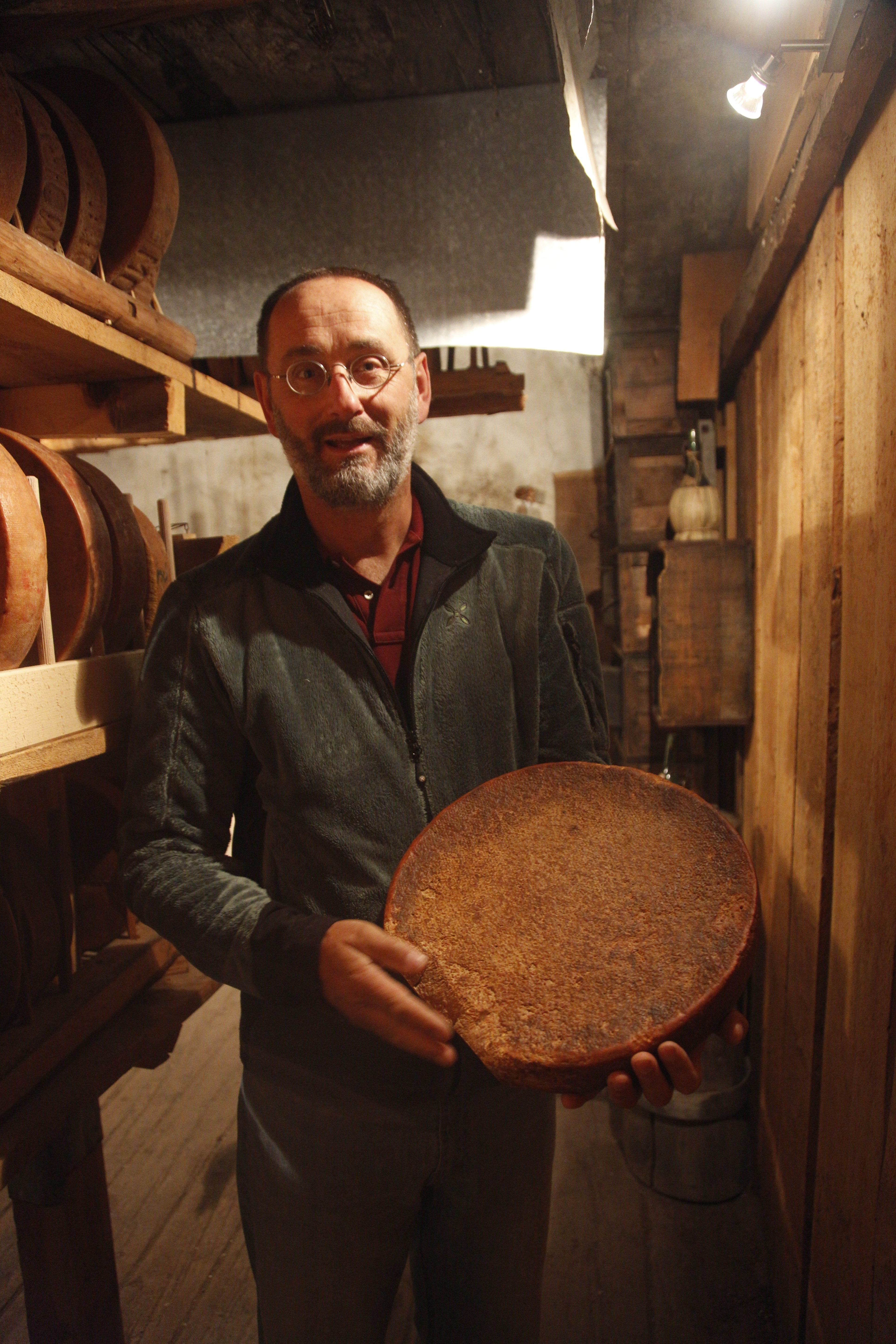 Jean-Jacques Zufferey holds a wheel of 149-year-old cheese.