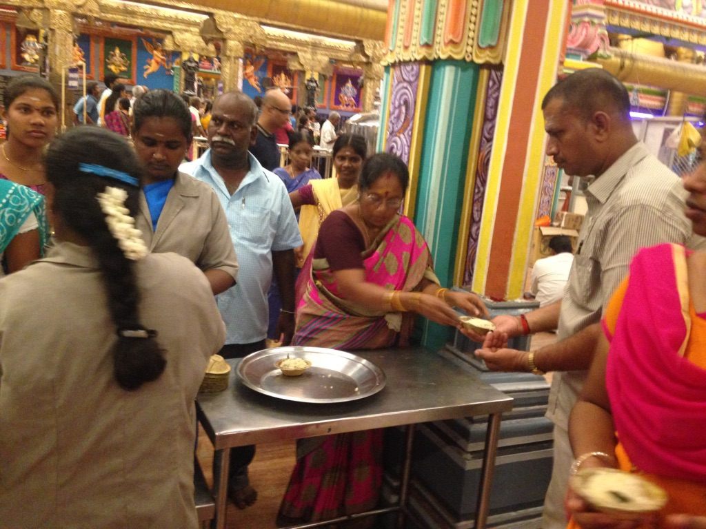 Distribution of pongal temple prasad to devotees at Manakkula Vinayagara Temple in Pondicherry.