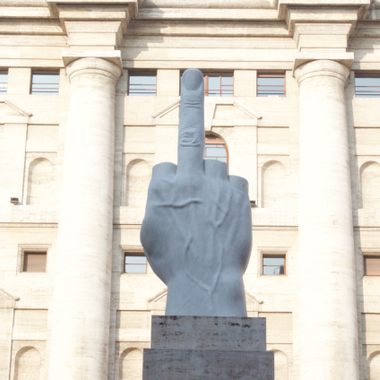 The statue with Palazzo Mezzanotte on the background