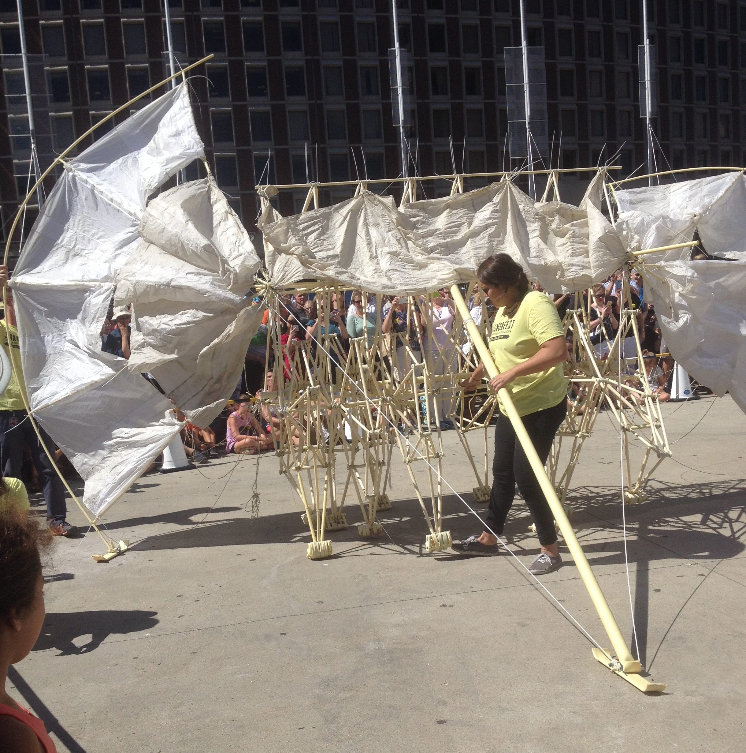 A Peabody Essex Museum volunteer coaxes a Strandbeest forward. (Photo: Atlas Obscura)