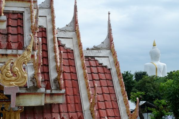 View of the cement Buddha statue from the main temple at Wat Phai Rong Wua.