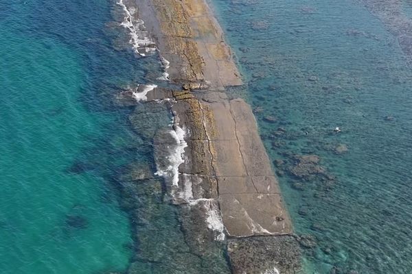 The submerged wall becomes visible during exceptionally low tides along the coast of Nhon Hai, Quy Nhon.