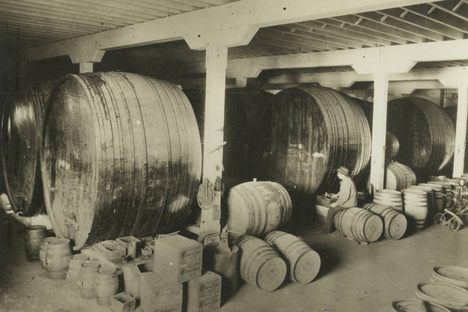 Interior of a winery with large casks, Los Angeles, c. 1910. 