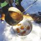 Boiling maple syrup being turned into sugar on snow.