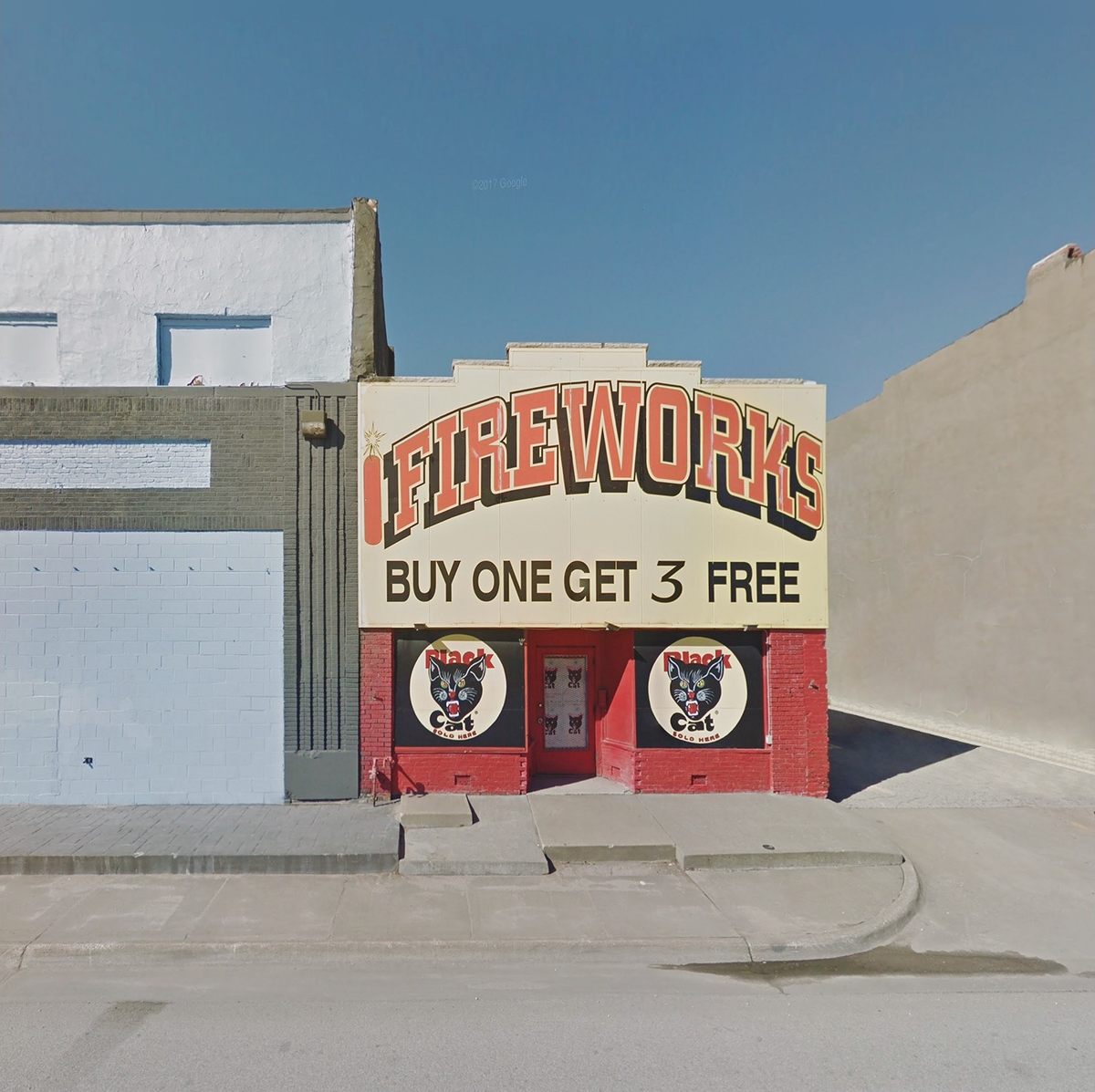 Against the sand-colored surroundings, the signage on this American fireworks shop is big and bright.