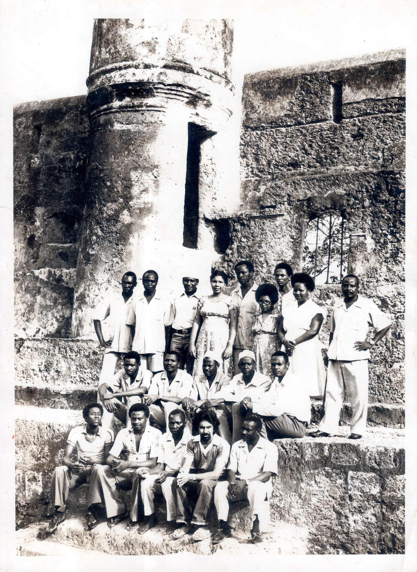 The individuals in this staff photo taken at Fort Jesus in 1980 have been identified. Top row (L to R): Charo Chengo, Joel Kang’ethe, former chief curator Ali Abubakar, Khifa Soud, Tingali Ngoa, Susan Taki, Wazwa Mwadime, Mary Mwakundia, and Charo Tsuma;
middle row (L to R): Ali Kamwaga, Mambo Banju, Babu Mwamwero, Mohammed Issa Loo, and Abdulrahman Mwinzangu;
bottom row (L to R): Harith Swaleh Baile, Francis Taki, Mitsanze Mramba, Azaad Nassir, and Kenga Nzai.