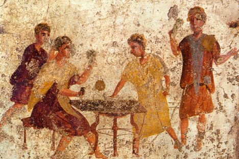 A fresco from Pompeii shows people playing something resembling a board game on a small table.