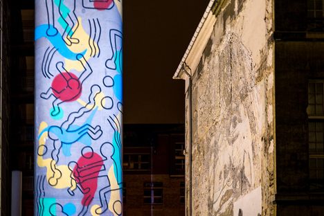 The Keith Haring Tower, lit during the night.