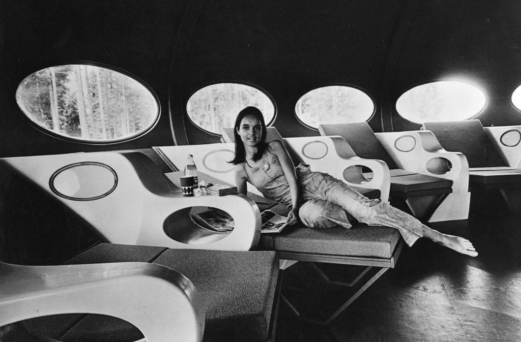 A woman reclines in the living room of a modern portable house called 'Futuro', 1969.