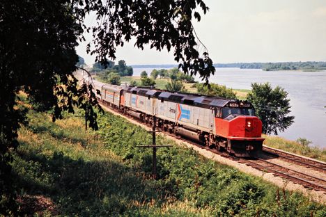 Amtrak train No. 10, the North Coast Hiawatha, on the Milwaukee Road main line along the Mississippi River at Dakota, Minnesota, in 1975, with the "Bloody Nose" paint scheme. 