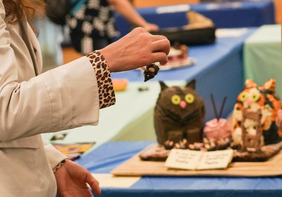 At Berkeley's Edible Books Festival, an attendee eats a chocolate mouse from "The Tails of Two Kitties."