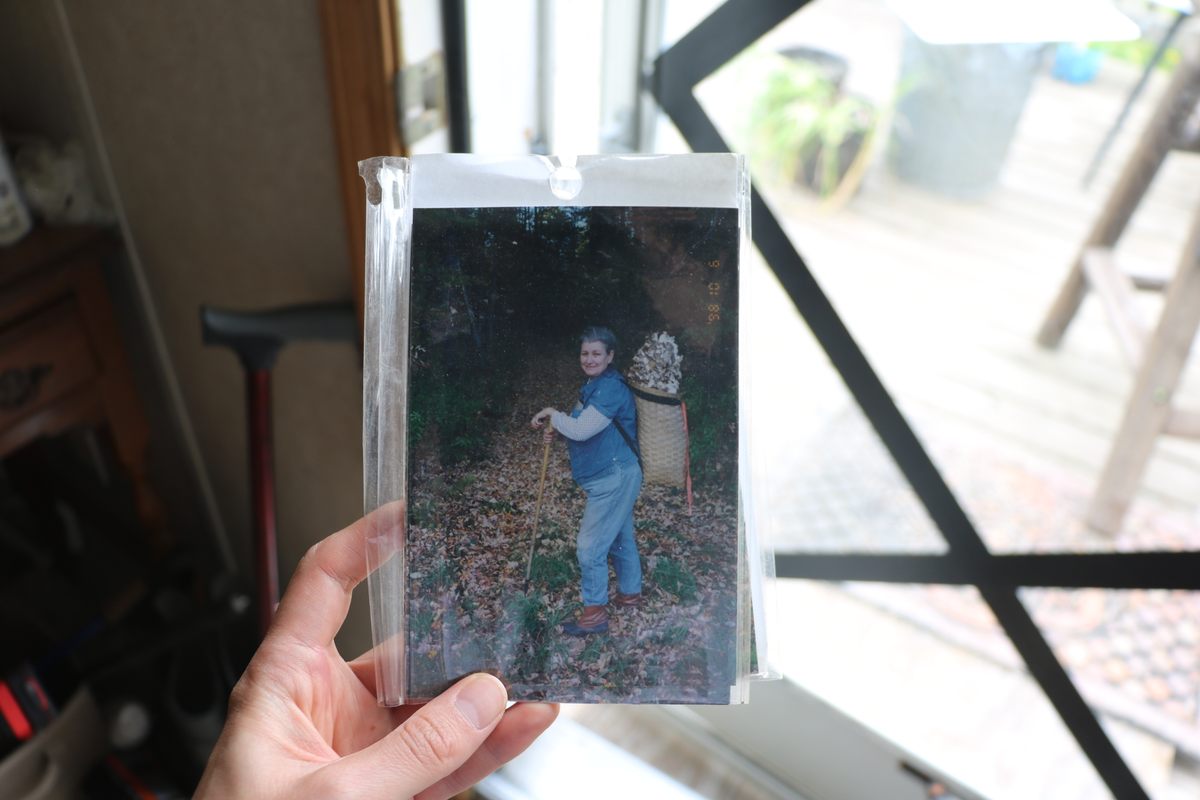A young Nova Kim with a satchel of mushrooms on her back.