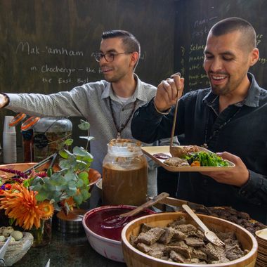 Louis Trevino (left) and Vincent Medina (right) plate traditional food at Cafe Ohlone.
