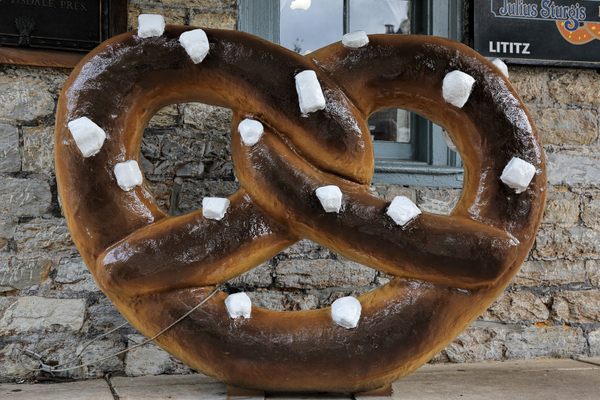 Pose with a giant pretzel outside the landmark bakery.