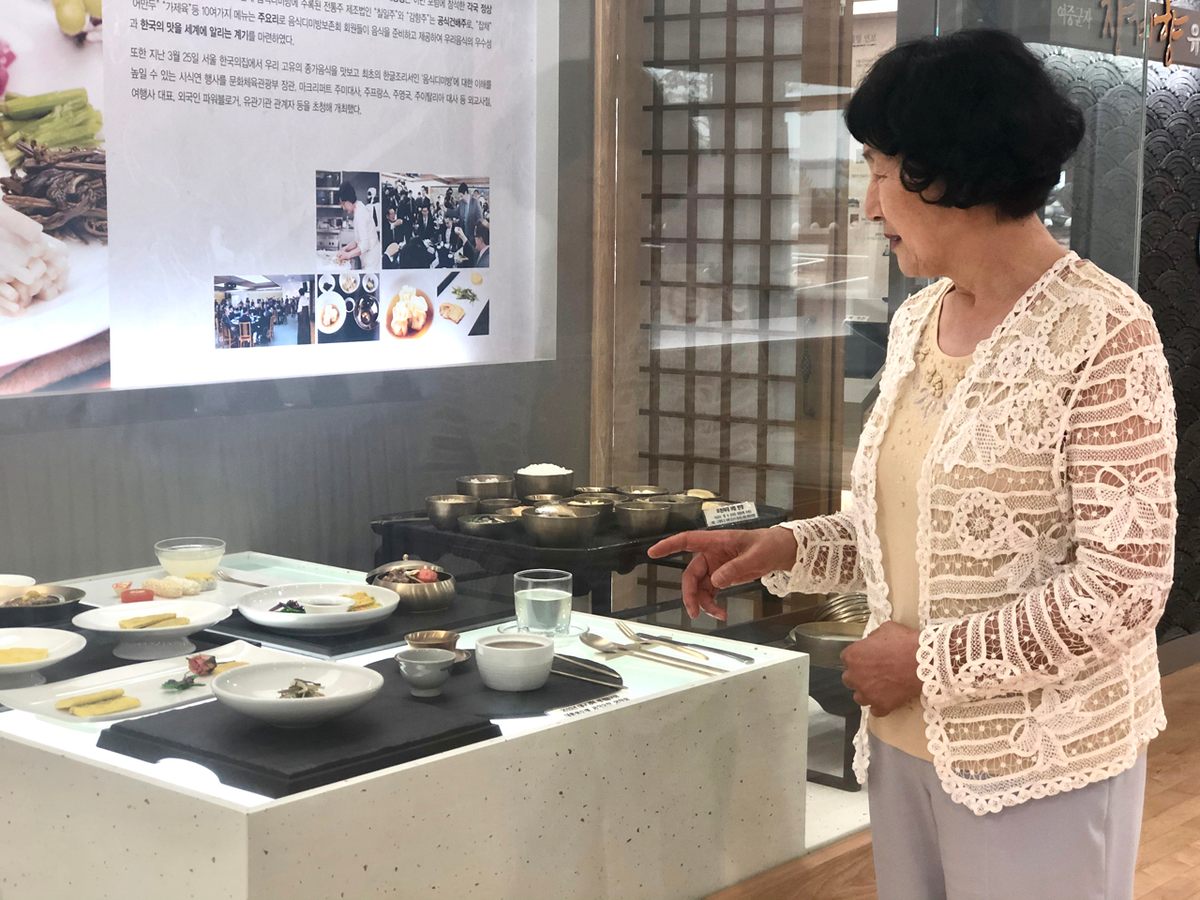 Lady Jo points out one of the dozens of food models based on Lady Jang's dishes, inside the Eumsik-Dimibang Exhibition Center.