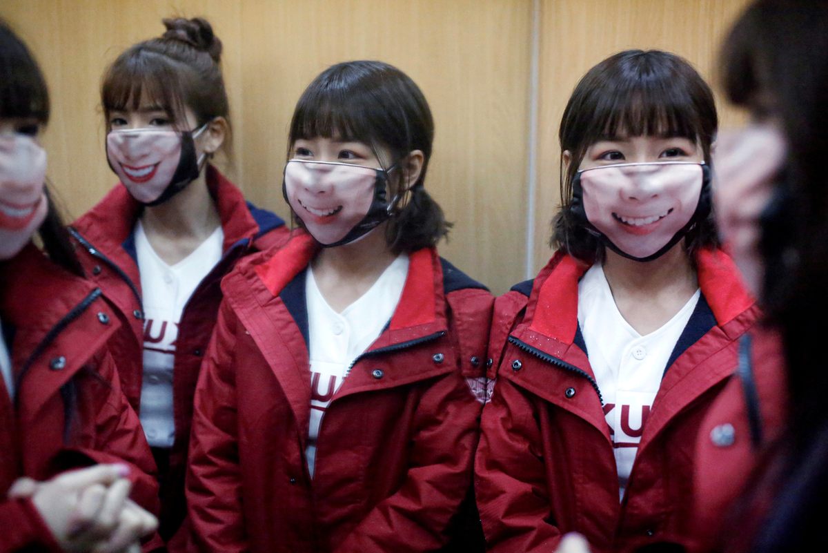 Cheerleaders in Taoyuan City, Taiwan, wear face masks at the first professional baseball league game of the season, April 11, 2020.