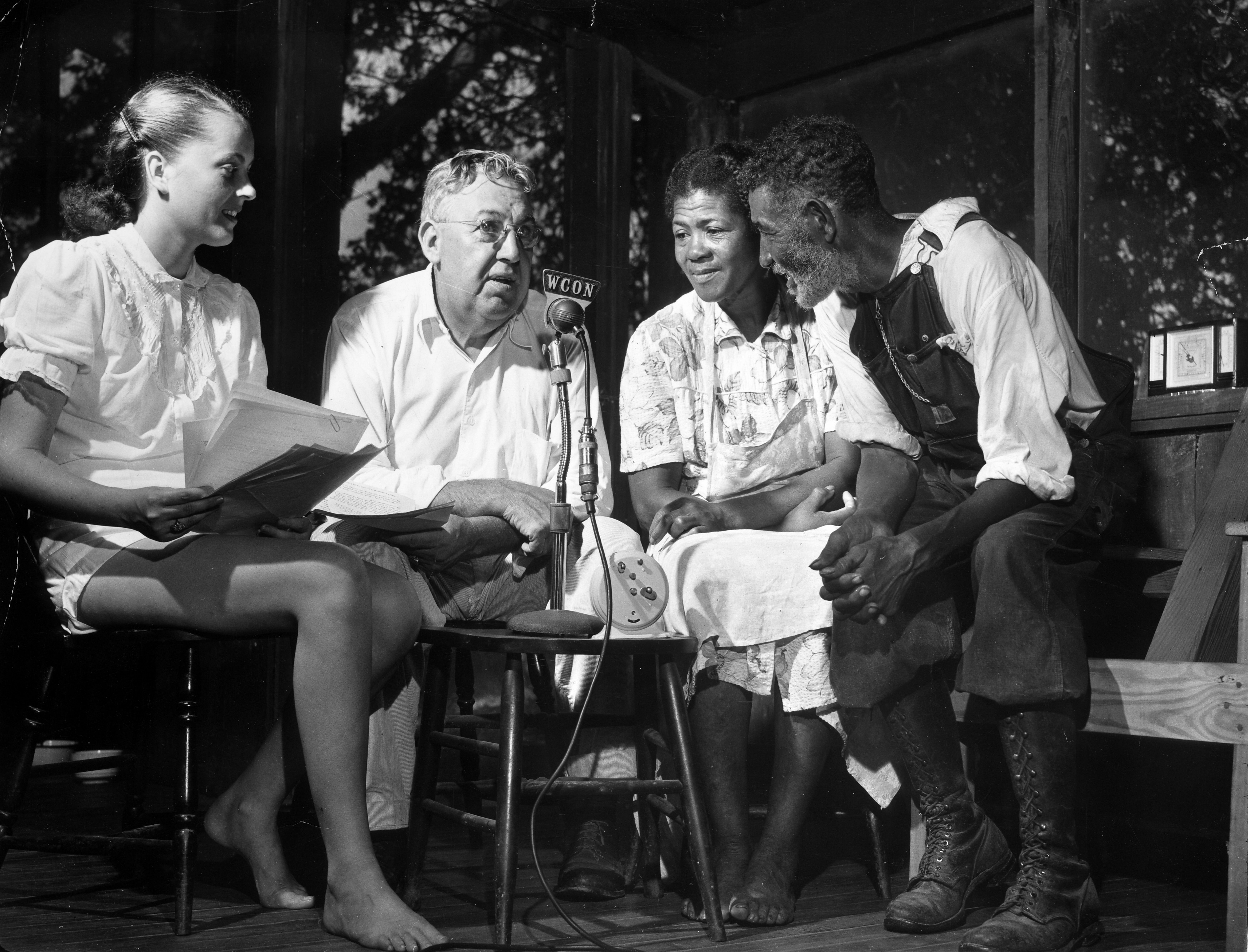Channing Cope, second from left, broadcasts his radio show from his front porch.