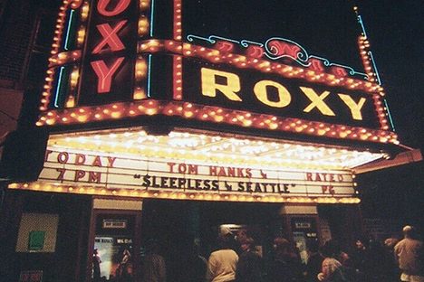 The exterior of the Roxy Theatre, with its ornate neon marquee. 