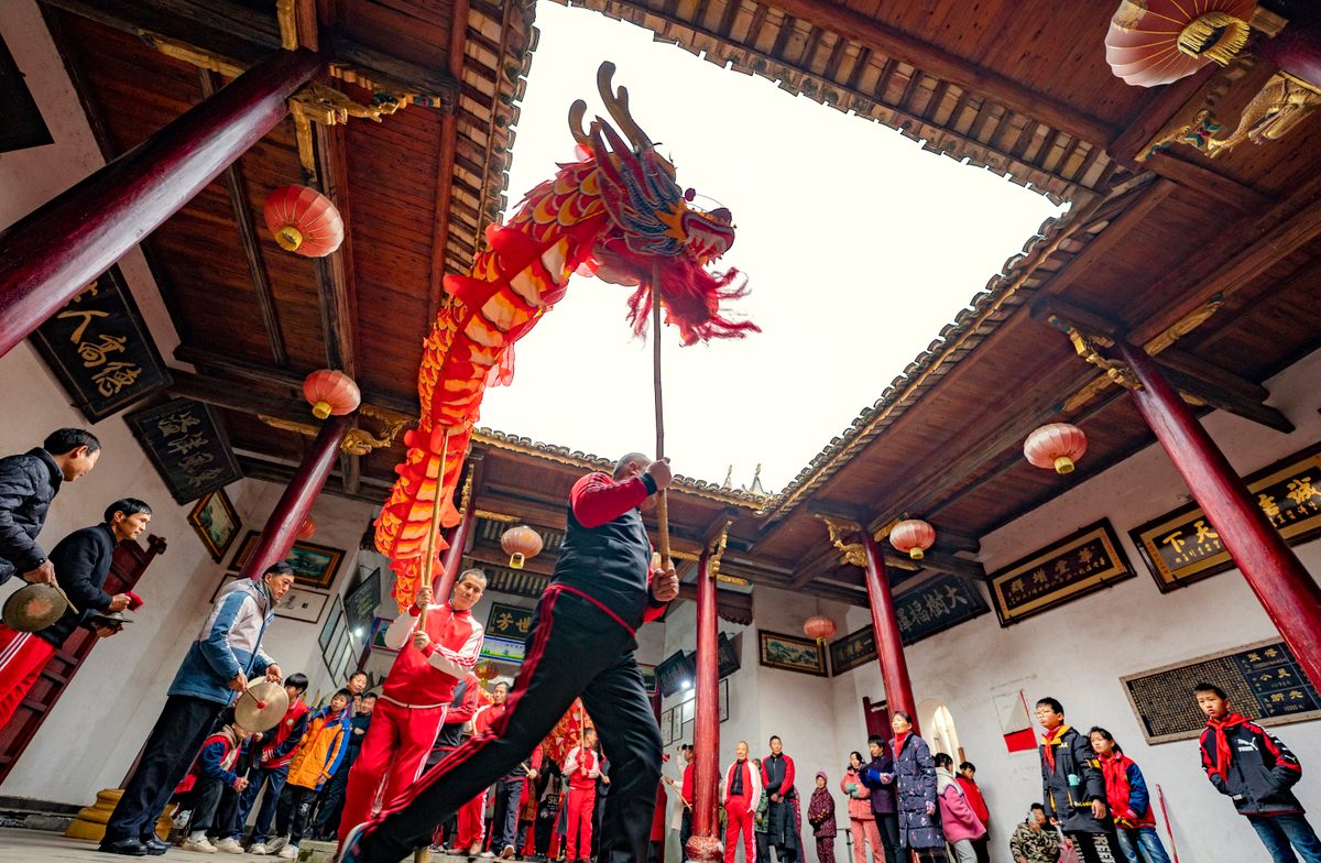 People practice a dragon dance ahead in Xinyu, Jiangxi Province, China. (January 14, 2022) 