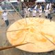 Members of the Giant Omelette Brotherhood stir more than 15,000 eggs on March 28, 2016, on the main square of Bessieres, France.