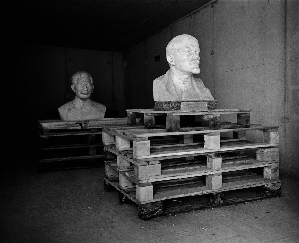 <em>Discarded Monuments, Memento Park, Hungary</em> (2017): “This is probably the most famous statue park in Eastern Europe. It’s only about 40 minutes outside Budapest, but the bus only comes by every two hours or so, and if you miss the last one, you’re screwed. So the day I shot I made sure to get back to the bus stop with plenty of time—but then, of course, I got bored waiting. So I wandered around the back of the building and discovered a basement room, open to the outdoors, with these busts propped up on pallets. In some ways, they’re even eerier than the statues on display in the park.”