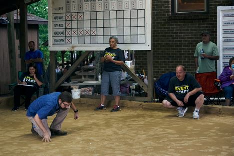 In rolley hole, two teams of two people compete to sink their marbles into three small holes in the middle of the marble yard 12 times in a prescribed order.