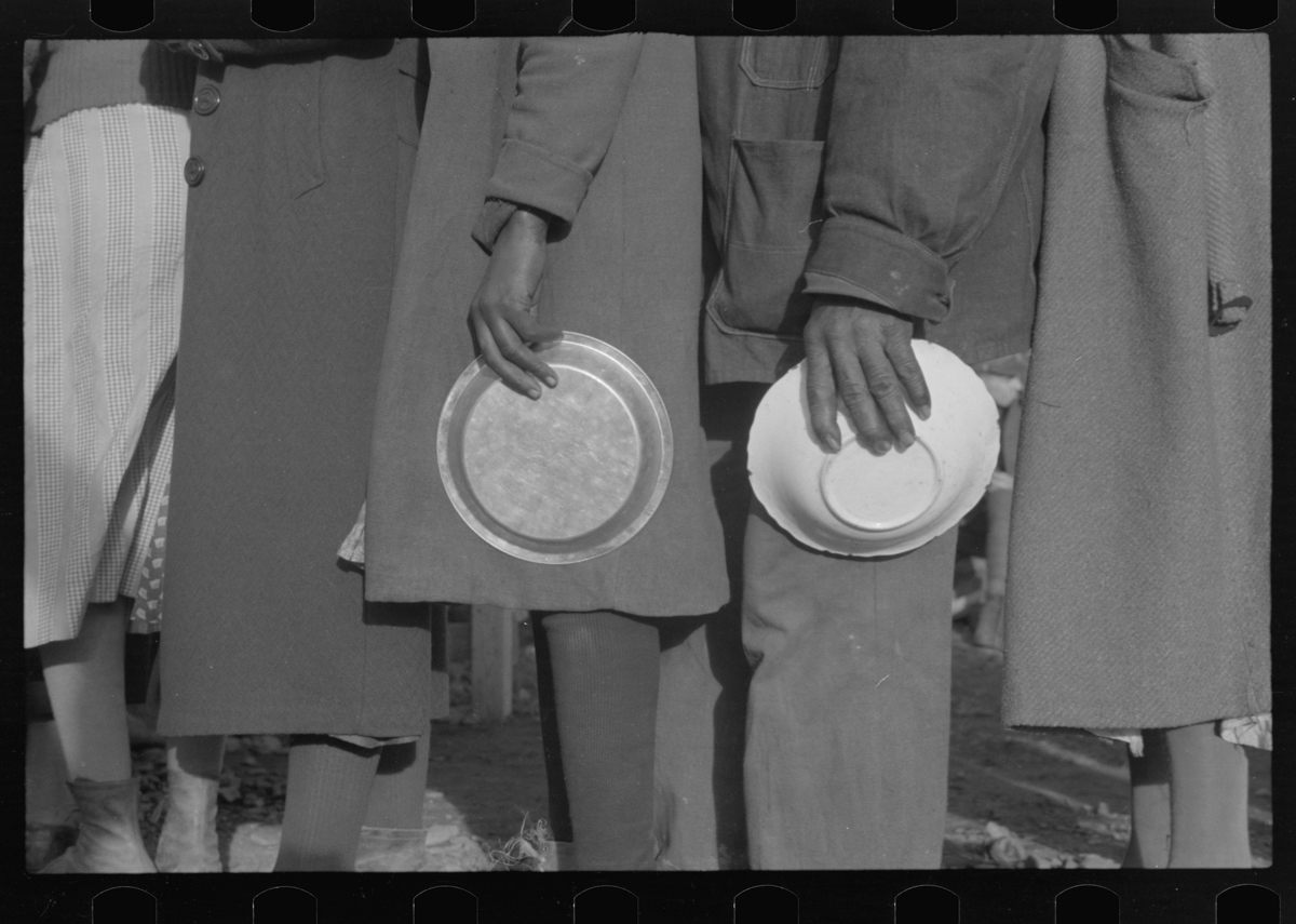<em>Negroes in the lineup for food at mealtime in the camp for flood refugees, Forrest City, Arkansas.</em>