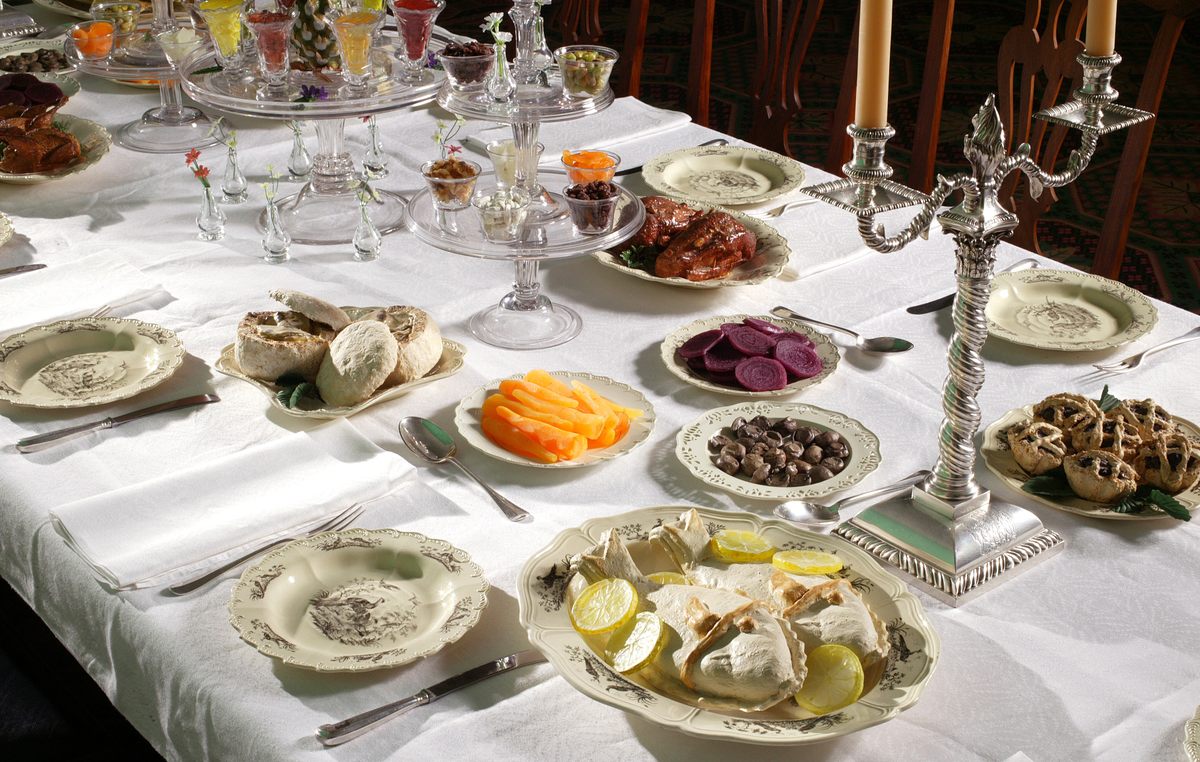 Colonial Williamsburg's Palace Supper room set with faux food: carrots, beets, meat pies, fish pies, jellies, small cups of nuts and dried fruit (known as sweet meats), and biscuits filled with mushrooms.