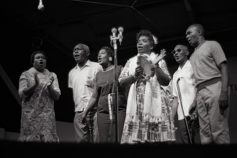 Bessie Jones (with tambourine) felt a “call to teach" and to share the  rich Black musical tradition she grew up with.