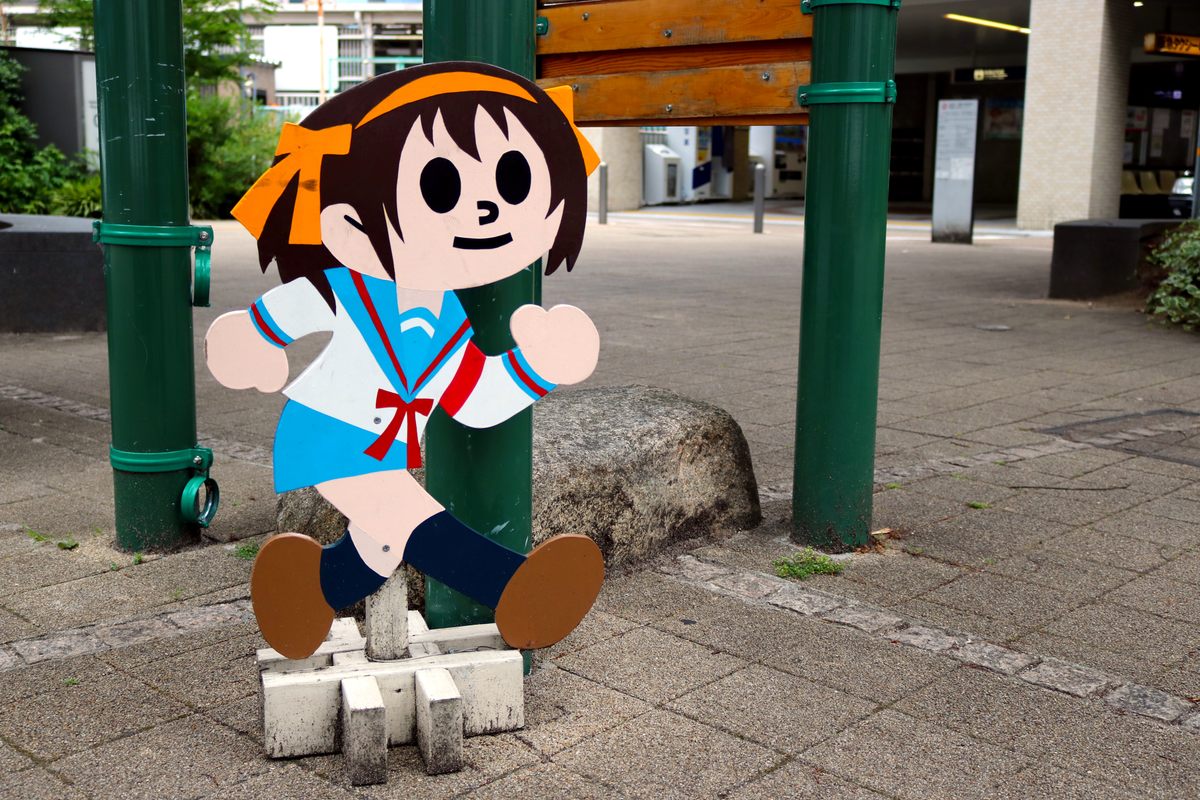 Anime designs are often used in the local, hand-painted signs, such as this one in front of the Nishimiya-Kitaguchi train station.